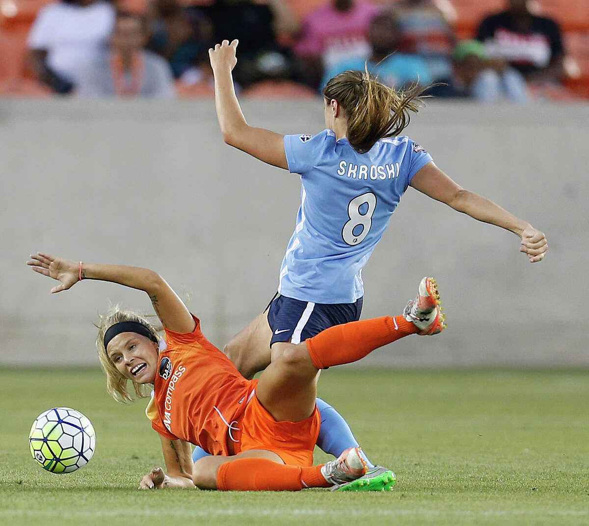 Dash forward Rachel Daly battles Sky Blue FC defender Erica Skroski (8) for control of the ball in the first half of Friday's game at BBVA Compass Stadium.
