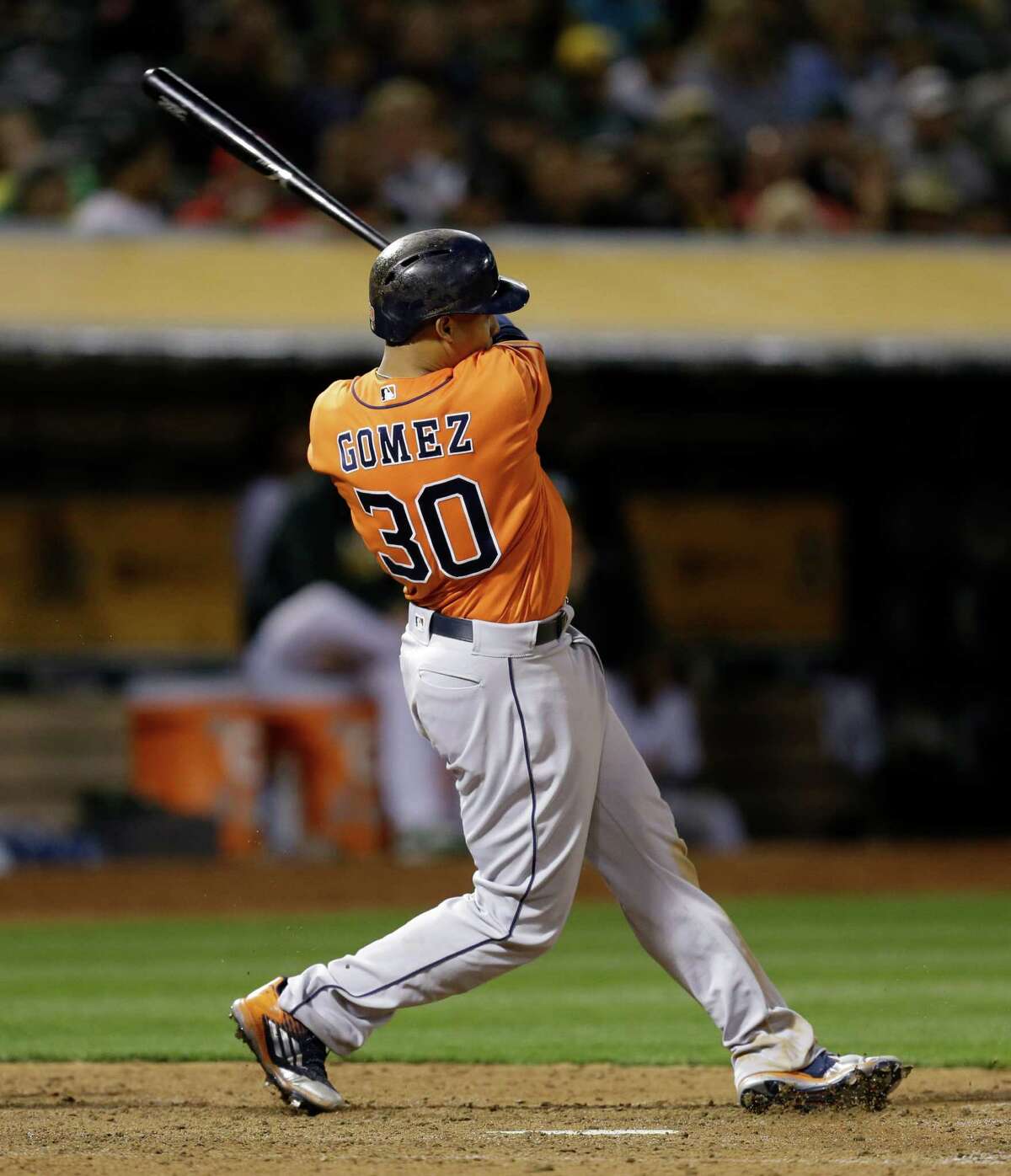 Houston Astros' Carlos Gomez swings for an RBI ground rule double off Oakland Athletics' Sean Doolittle in the sixth inning of a baseball game Friday, April 29, 2016, in Oakland, Calif. (AP Photo/Ben Margot)
