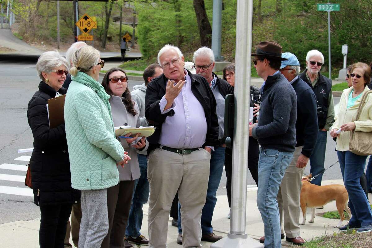 During a tour of the Saugatuck neighborhood, Werner Liepolt explains the historical significance of the area -- proposed for listing on the National Register of Historic places -- to Jenny Scofield, National Register coordinator for the State Historic Preservation Office.