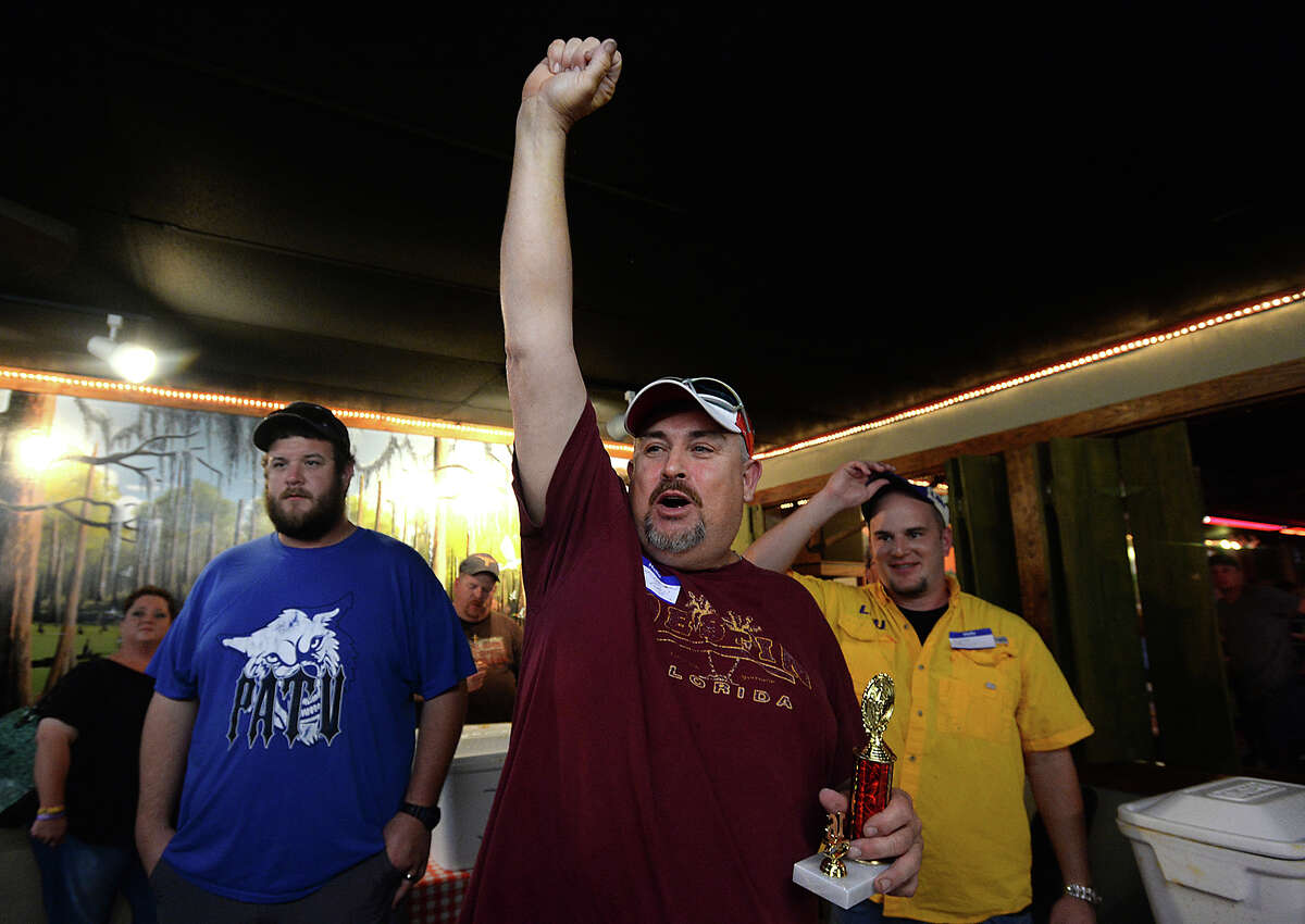 Keith Weinschel celebrates after co-winning the crawfish eating contest Friday night at Larry's French Market in Groves. Contestants had 15 minutes to prove their worth, digging into containers filled with 20 pounds of steaming hot crawfish, as they vied for the grand prize of a Bayou Classic Crawfish Pot and burner or Bayou Classic 25-quart Ice Chest. Photo taken Friday, April 29, 2016 Kim Brent/The Enterprise