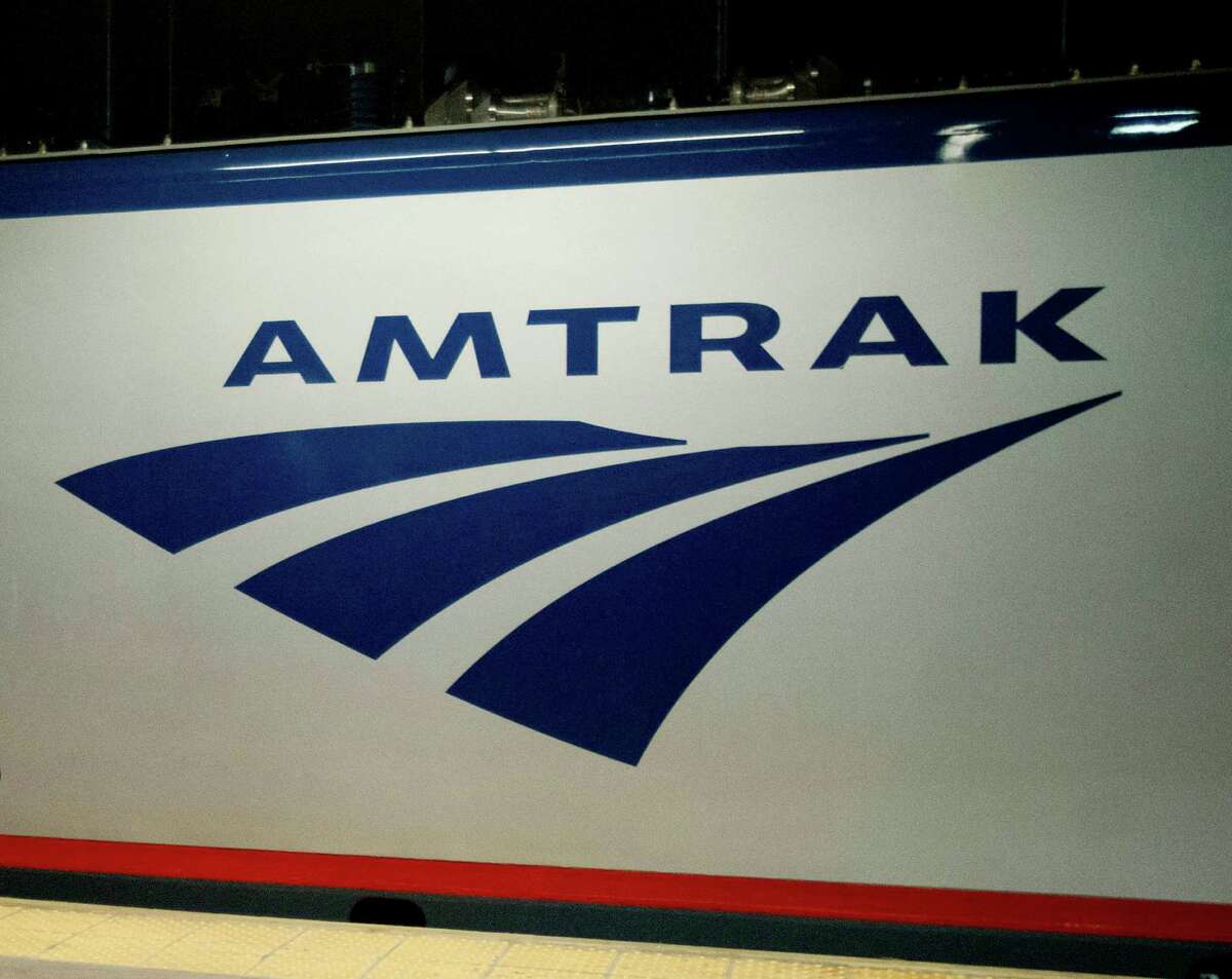 FILE - In this Feb. 6, 2014 file photo, an Amtrak logo is seen on a train at 30th Street Station in Philadelphia. (AP Photo/Matt Rourke, File)