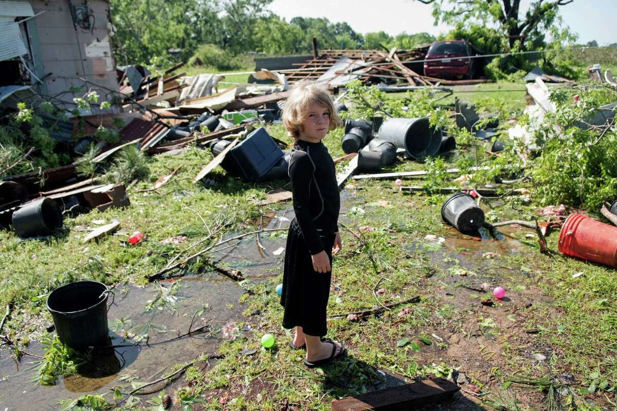 Memphis Melton, 7, looks at the destruction in his aunt's backyard in Lindale, Texas Saturday, April 30, 2016. A suspected tornado came through the area Friday night. /Tyler Morning Telegraph via AP) MANDATORY CREDIT