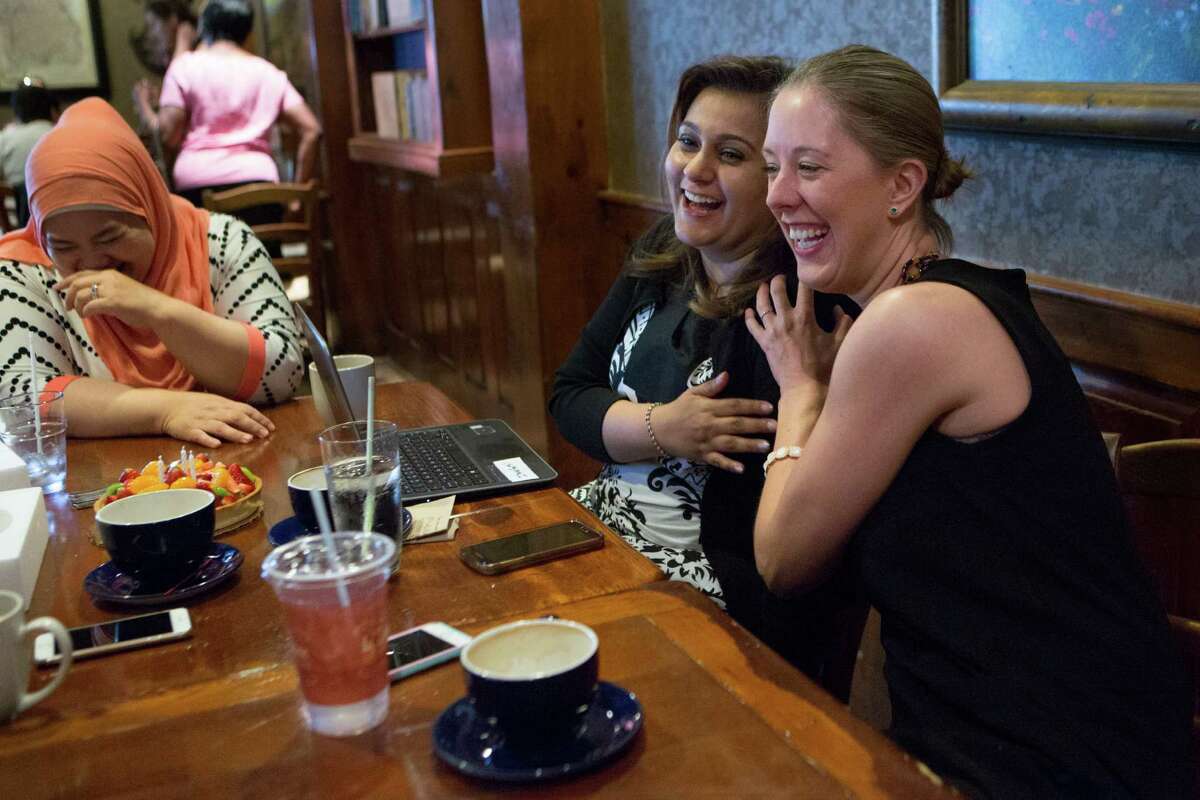Lily Nasar, right, and Saira Jilani laugh with Bibi Khan, far left, during the group's Friday lunch at La Madeleine. They and several others meet every Friday to share their experiences as women and Muslim members of the community.