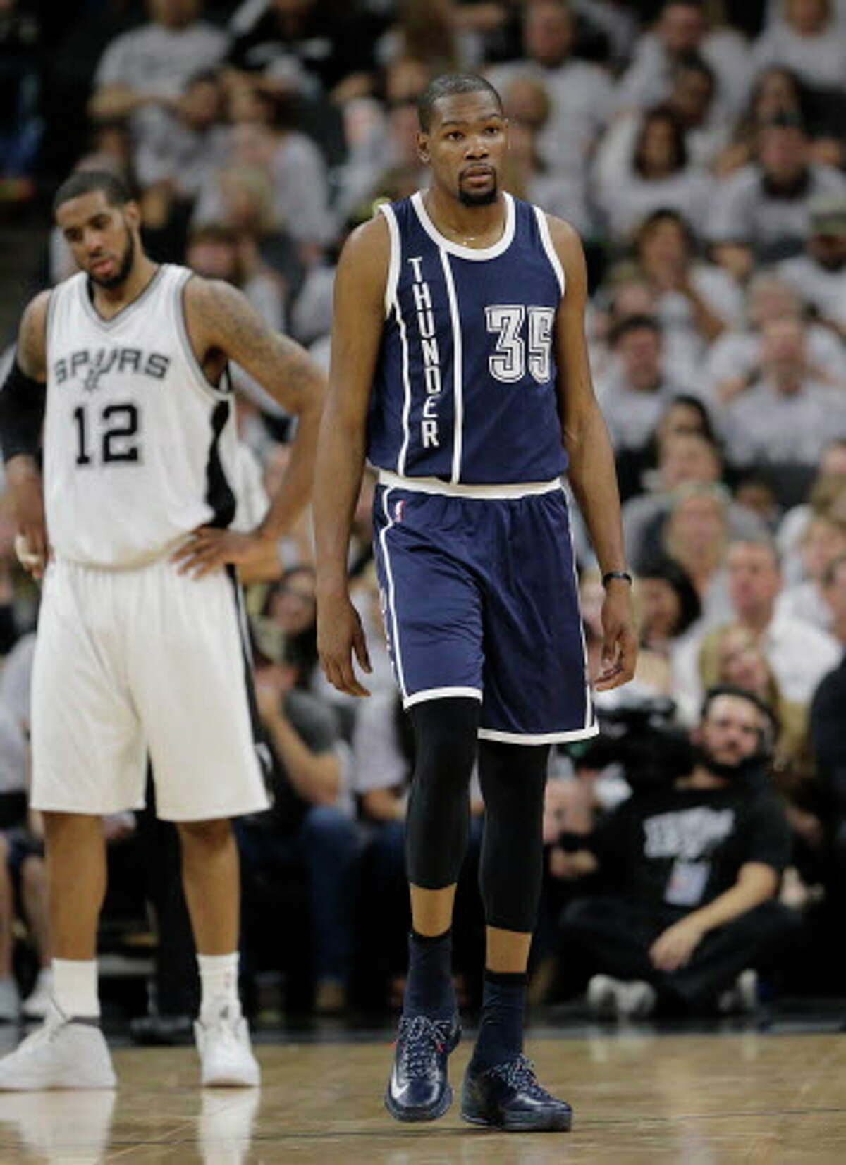 Oklahoma City Thunder forward Kevin Durant (35) walks up court during the first half in Game 1 of a second-round NBA basketball playoff series as San Antonio Spurs forward LaMarcus Aldridge (12) looks on, Saturday, April 30, 2016, in San Antonio. (AP Photo/Eric Gay) Spurs vs. Thunder NBA playoffs Game 1.