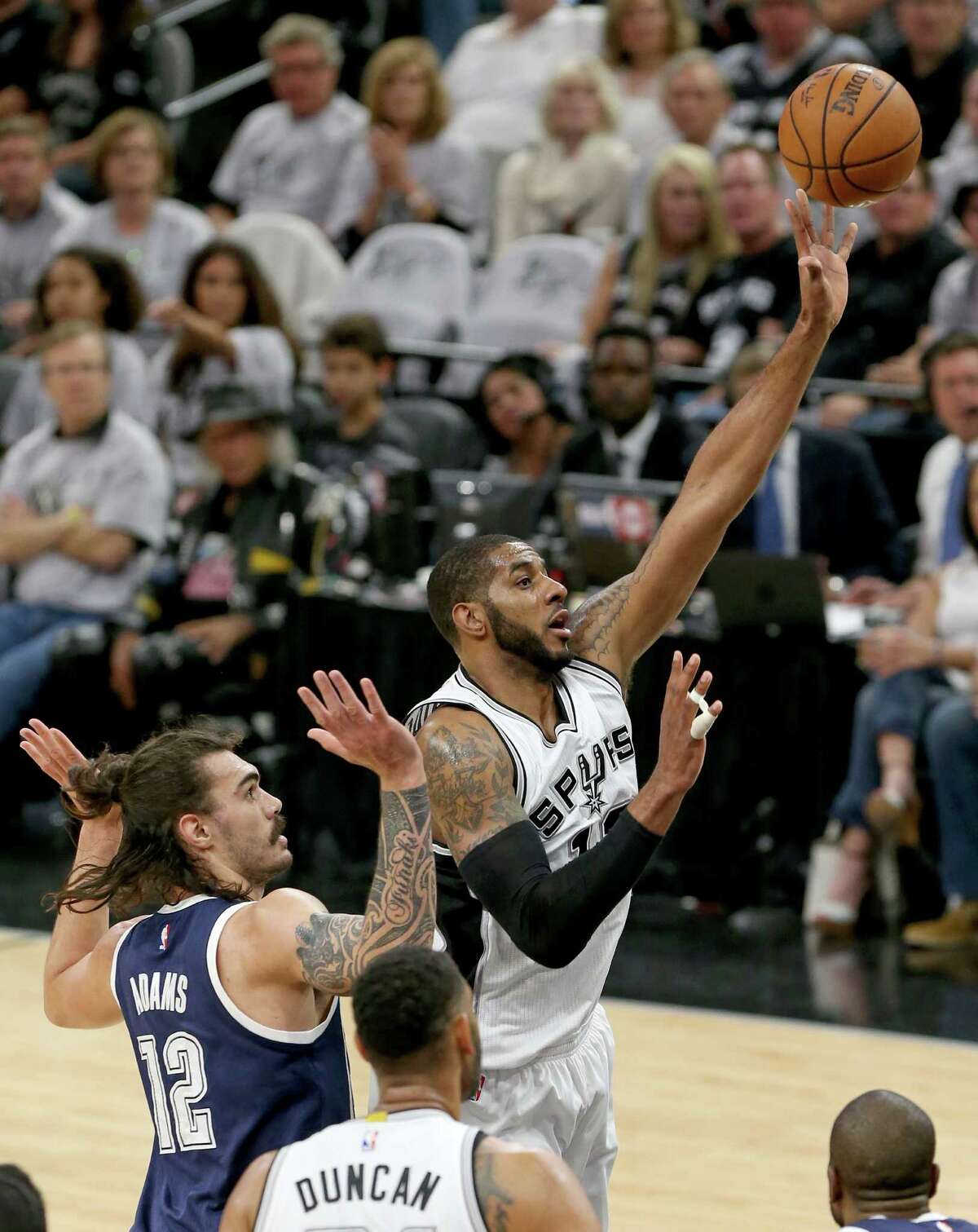 The Spurs' LaMarcus Aldridge, right, scores two of his game-high 38 points as San Antonio never trailed Saturday night en route to dominating the Thunder.