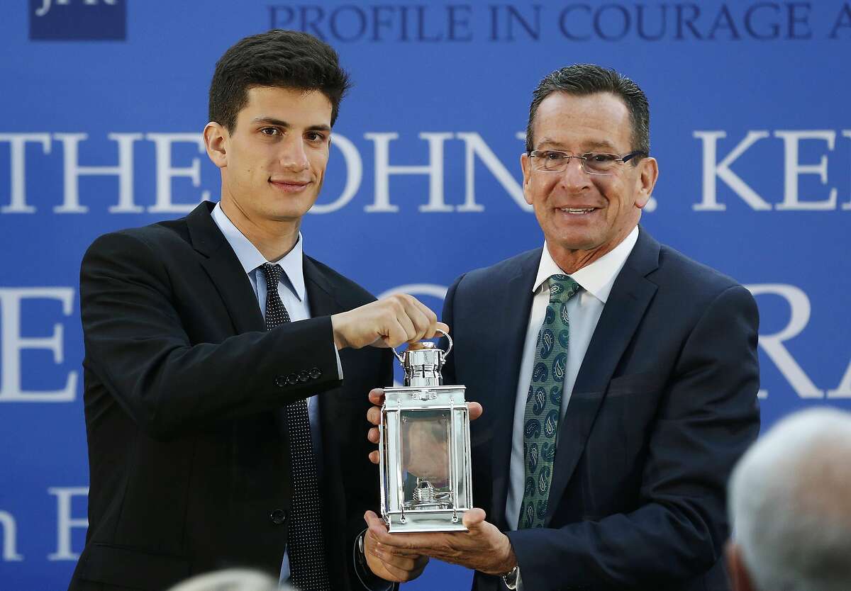 Jack Schlossberg, left, and Connecticut Gov. Dannel P. Malloy pose with the John F. Kennedy Profile in Courage Award at the John F. Kennedy Presidential Library in Boston, Sunday, May 1, 2016. Schlossberg, presented Malloy, a Democrat, with this year's award for his vocal support of refugee resettlement. (AP Photo/Michael Dwyer)