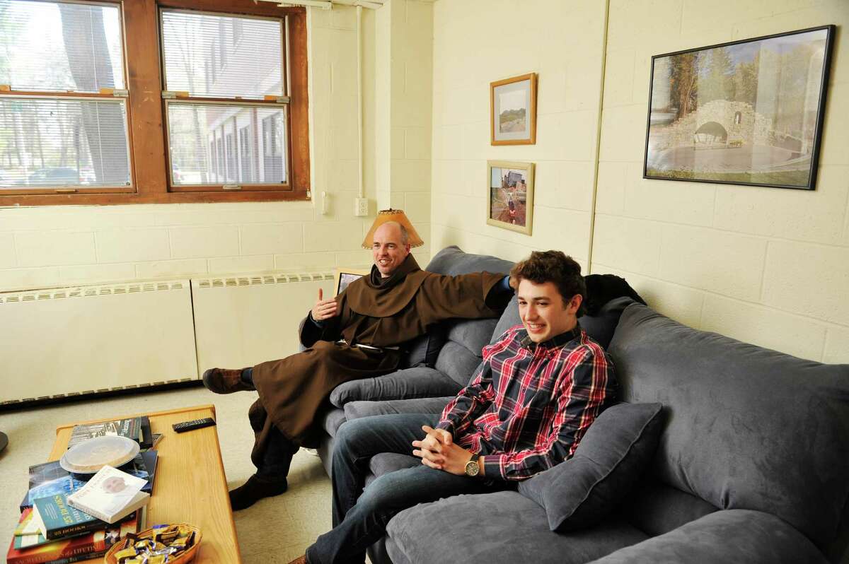 Siena College, friar, Father Larry Anderson, left, and freshman student Vincent Mills talk in Father Anderson's room, which is in the residence hall with students, on Wednesday, April 27, 2016, in Loudonville, N.Y. (Paul Buckowski / Times Union)