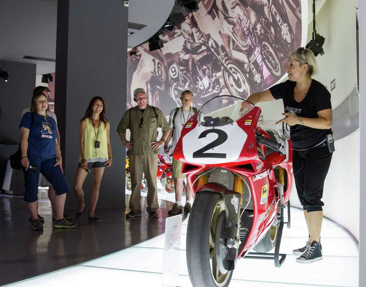 In this July 6, 2015 photo, a guide gives a tour of the Ducati Museum in the Borgo Panigale neighborhood of Bologna, Italy. The company is celebrating its 90th anniversary at its biannual World Ducati Week at the Misano race track from July 1-3, 2016. Tickets are free to visitors who live outside of Europe. (AP Photo/Erik Schelzig)
