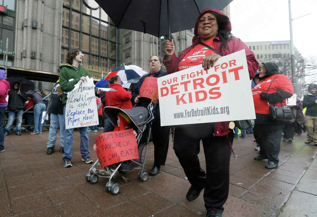 Detroit teachers march outside the district headquarters, Monday, May 2, 2016, in Detroit. Detroit Public Schools transition manager Steven Rhodes says 45,628 of approximately 46,000 students were forced to miss classes Monday as 1,562 teachers called in sick. The mass sick-out has forced the district to close 94 of its 97 schools. Detroit's schools are expected to be out of cash starting July 1. The state earlier gave the district $48.7 million in emergency funding to keep it open through June 30 as the Legislature considers a $720 million restructuring plan. (AP Photo/Carlos Osorio)