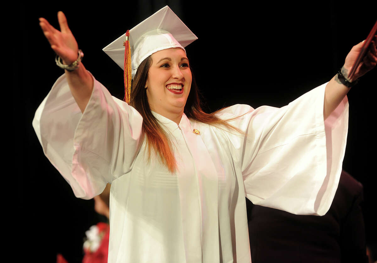 Nicole Cavallaro, of North Haven, opens her arms for a hug after receiving her diploma during the Bridgeport Hospital School of Nursing graduation at the University of Bridgeport in Bridgeport, Conn. on Monday, May 2, 2016.