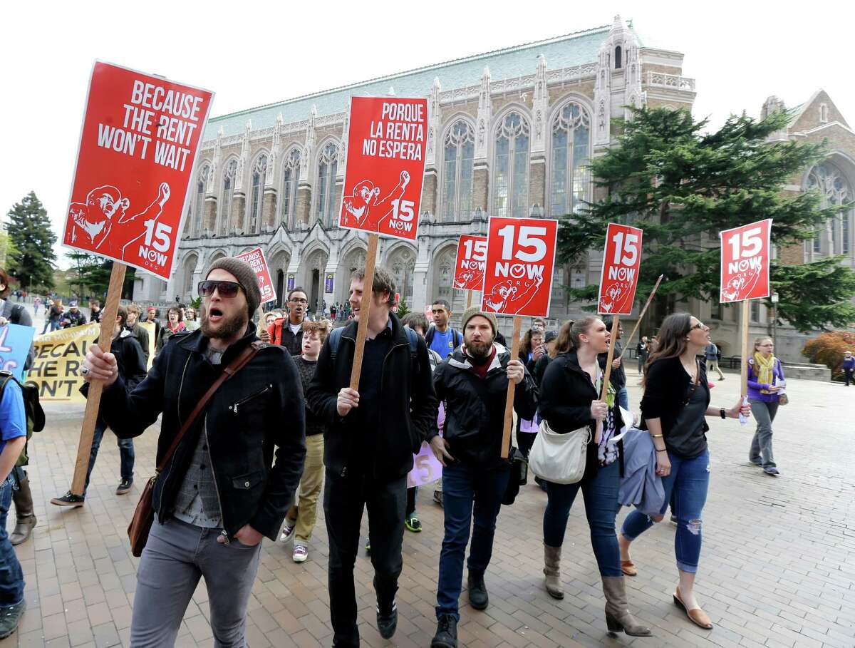 Protesters on the University of Washington campus in Seattle back higher wages for campus workers last year. The U.S. Supreme Court won't hear franchise owners' challenge to Seattle's minimum-wage law.