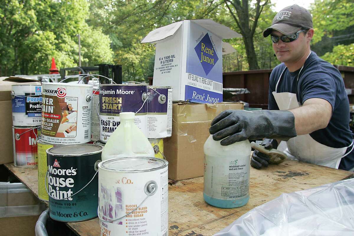 Clean Harbors employee Eric Kristoferson sorts through some of the household toxic waste that was during a past Household Hazardous Waste Day. The next one will be held Saturday at the Island Beach Parking Lot.