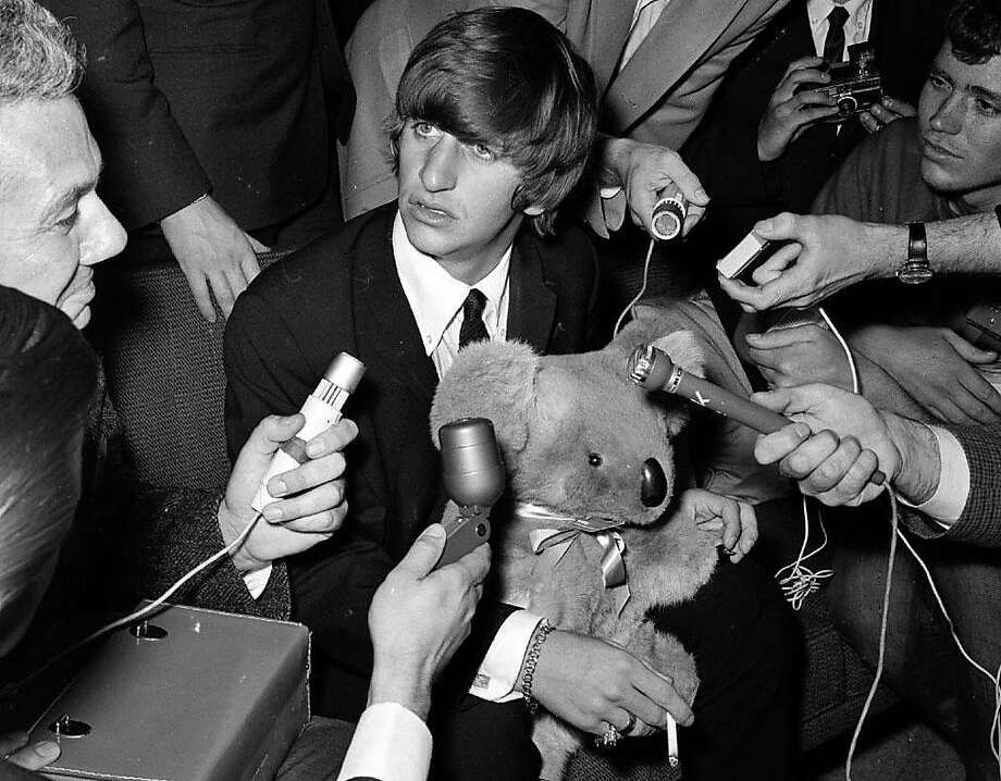 The Beatles' Ringo Starr encountered bedlam, and a lot of microphones, when he stopped at San Francisco International Airport on June 12, 1964, on his way to Australia to meet up with the band. Photo: Gordon Peters, The Chronicle 1964