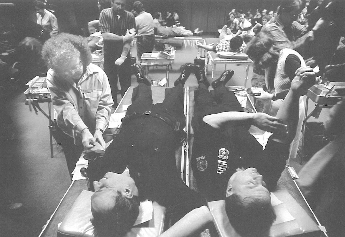 Patrolmen Robert Fano and David Chiappetta give blood at Greenwich Town Hall on Jan. 27, 1988. Juanita Russell, LPN, at left is the phlebotomist.