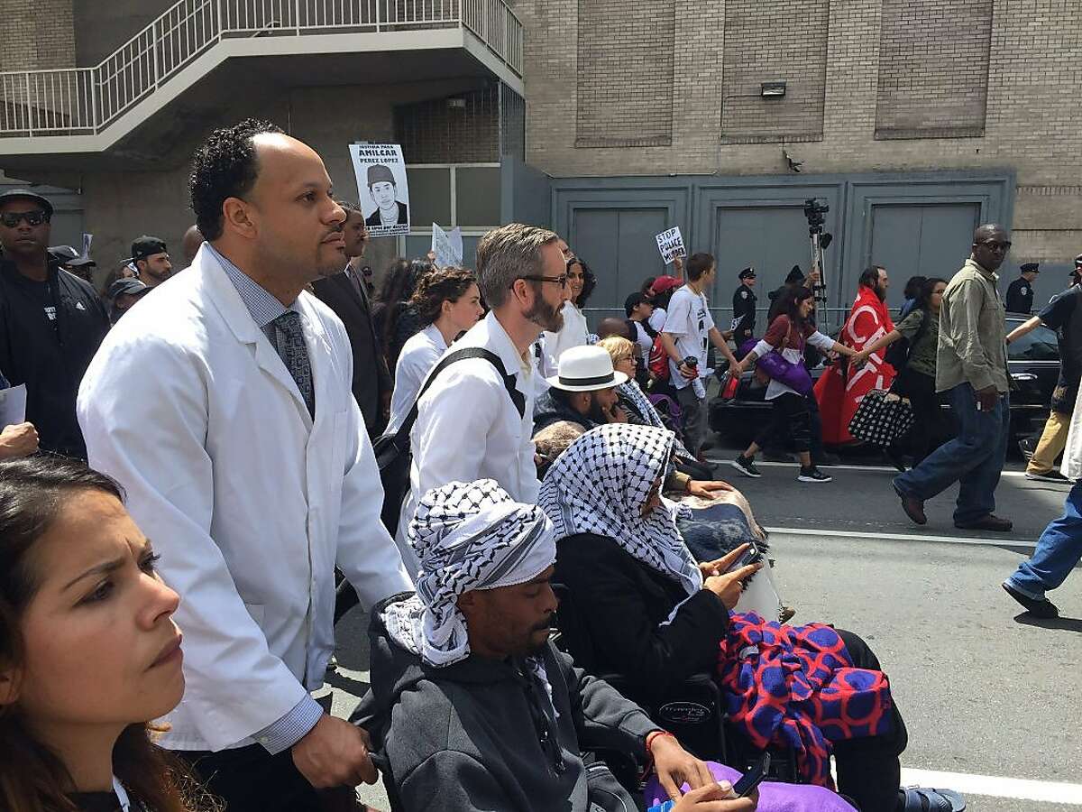 Protesters who have been on a hunger strike for 13 days march with others to City Hall demand that Police Chief Greg Suhr is fired May 3, 2016 in San Francisco, Calif.
