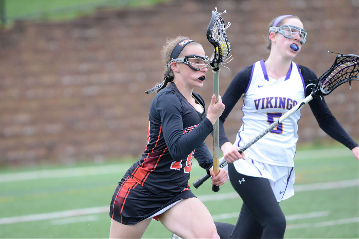 Stamford's Erica Stietzel carries as Westhill's Emma Jelliffe defends as Westhill High School hosts Stamford High School in girls varsity lacrosse in Stamford, CT on May 3, 2016.