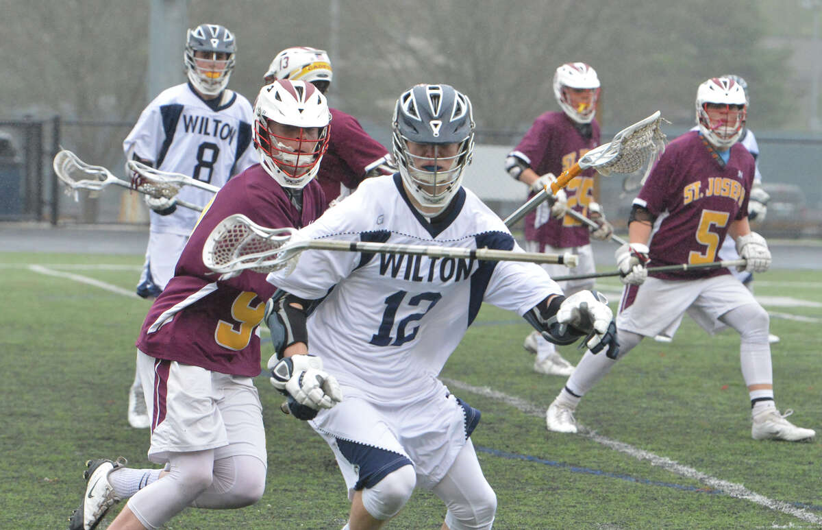 Wiltons #12 Zachary Zeyher loses his stick vs St Joes boys lacrosse at Wilton Conn. May 3 2016