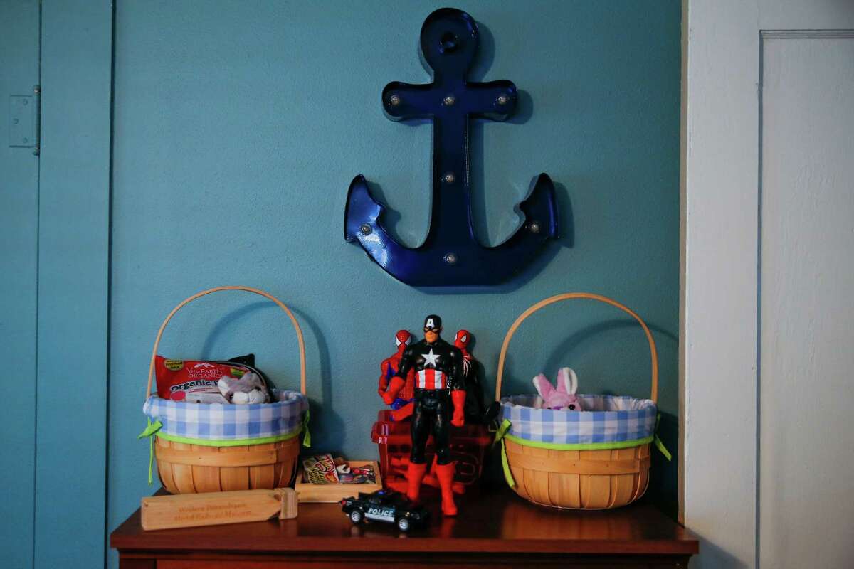 Action figures and Easter baskets sit last week on a bookshelf in the room of two foster kids who were removed from the home of their foster parents, who reported sexual abuse by the boys' older brother. ﻿
