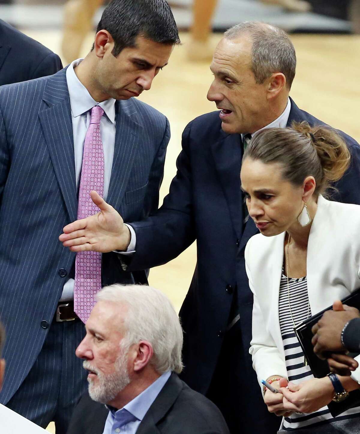 San Antonio Spurs assistant coaches James Borrego (from left clockwise) and Ettore Messina talk as assistant coach Becky Hammon listens to head coach Gregg Popovich talk with players during second half action against the Atlanta Hawks Saturday Nov. 28, 2015 at the AT&T Center. The Spurs won 108-88.