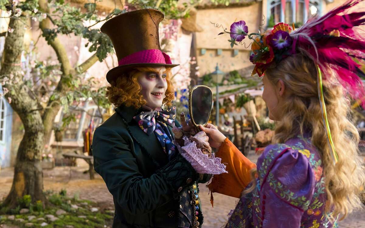 This image released by Disney shows Johnny Depp as the Mad Hatter, left, and Mia Wasikowska as Alice in a scene from "Alice Through the Looking Glass," premiering in US theaters on May 27. (Peter Mountain/Disney via AP)