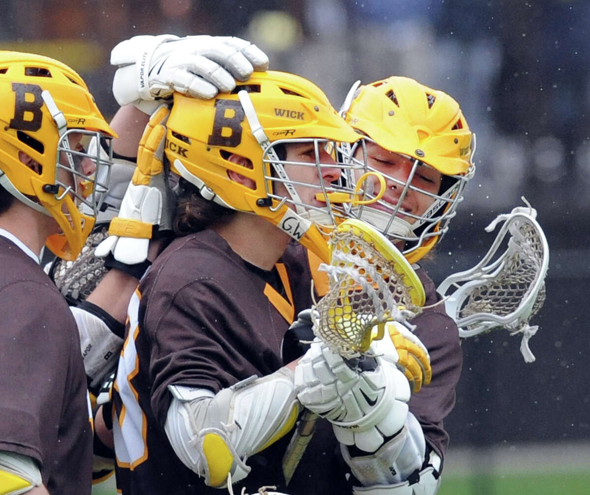 At center, David Pasini (#33) of Brunswick, is congratulated by teammates including Griffin Gelinas (#24), right, after Pasini scored a first quarter goal during the boys high school lacrosse match between Brunswick School and Choate Rosemary Hall at Brunswick in Greenwich, Conn., Wednesday, May 4, 2016.