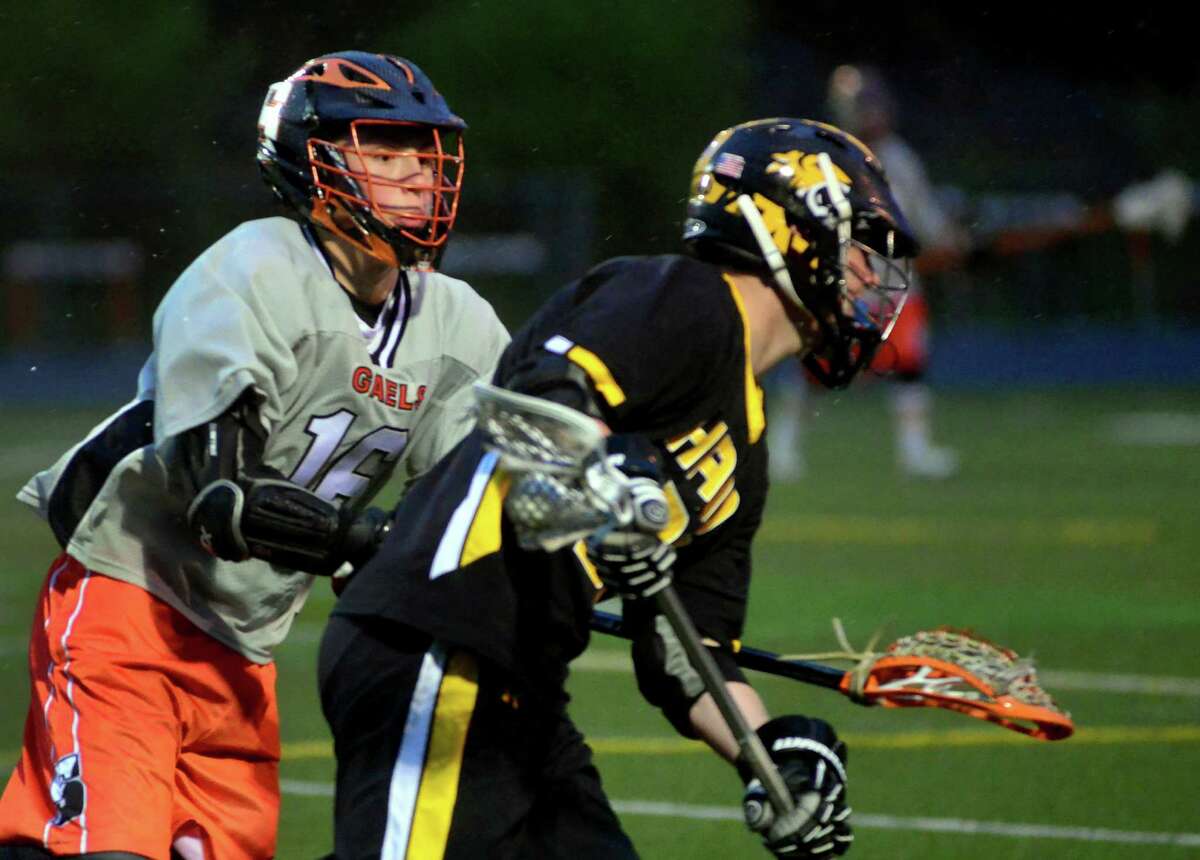 Shelton's Stephen Willey, left, blocks Daniel Hand's Mike Bartosic during boys lacrosse action in Shelton, Conn., on Wednesday May 4, 2016.