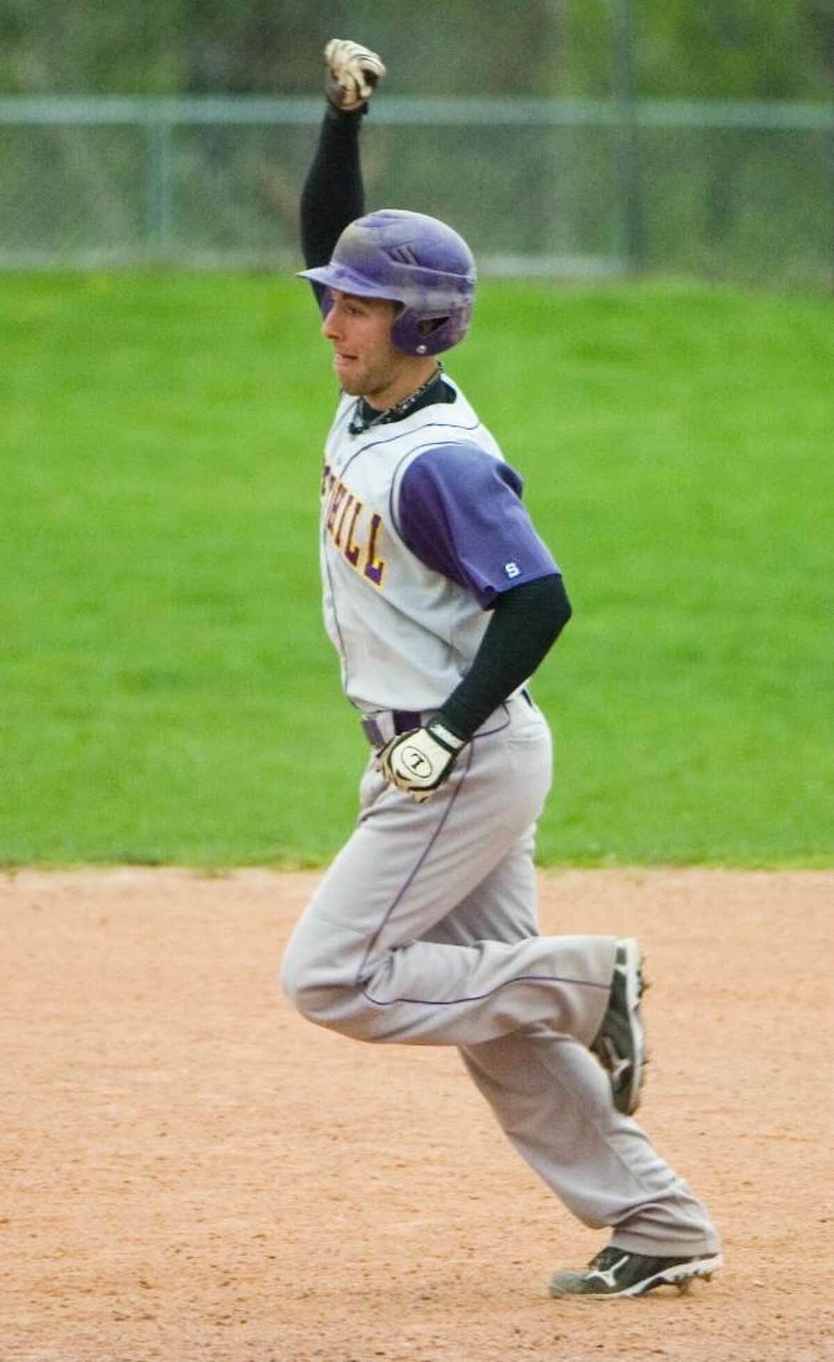 Westhill High School's Tyler Rich pumps his fist in the air in celebration after hitting a grand slam during a game against Staples High School in Stamford, Conn on April 16, 2010.