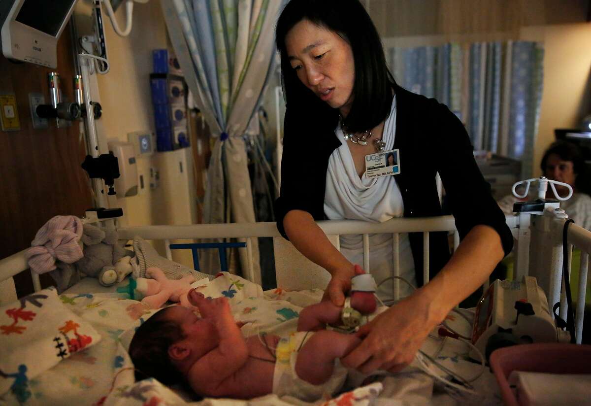 In this file photo, Dr. Yvonne Wu of UCSF Medical Center at Mission Bay examines a young patient in 2016. Columnist Caille Millner goes through a list of reasons of whether it's a good idea to have a kid in San Francisco.