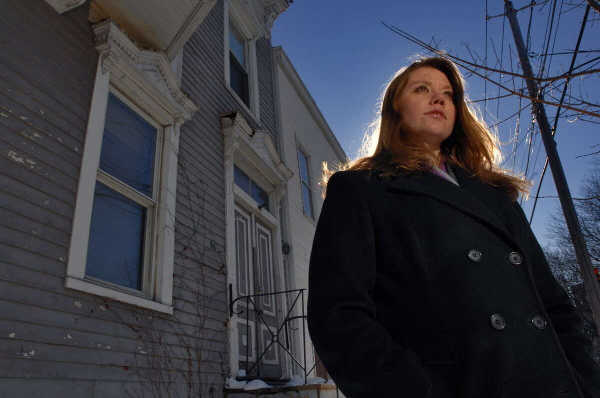 Times Union Staff photograph by Philip Kamrass -- Albany County assistant district attorney Jessica Blain-Lewis stands in front of 66 Ontario Street in Albany, NY on Monday February 19, 2007. She runs a narcotics eviction unit for the district attorney's office. The Ontario Street building was a target in the program.FOR MICHELE MORGAN BOLTON STORY.