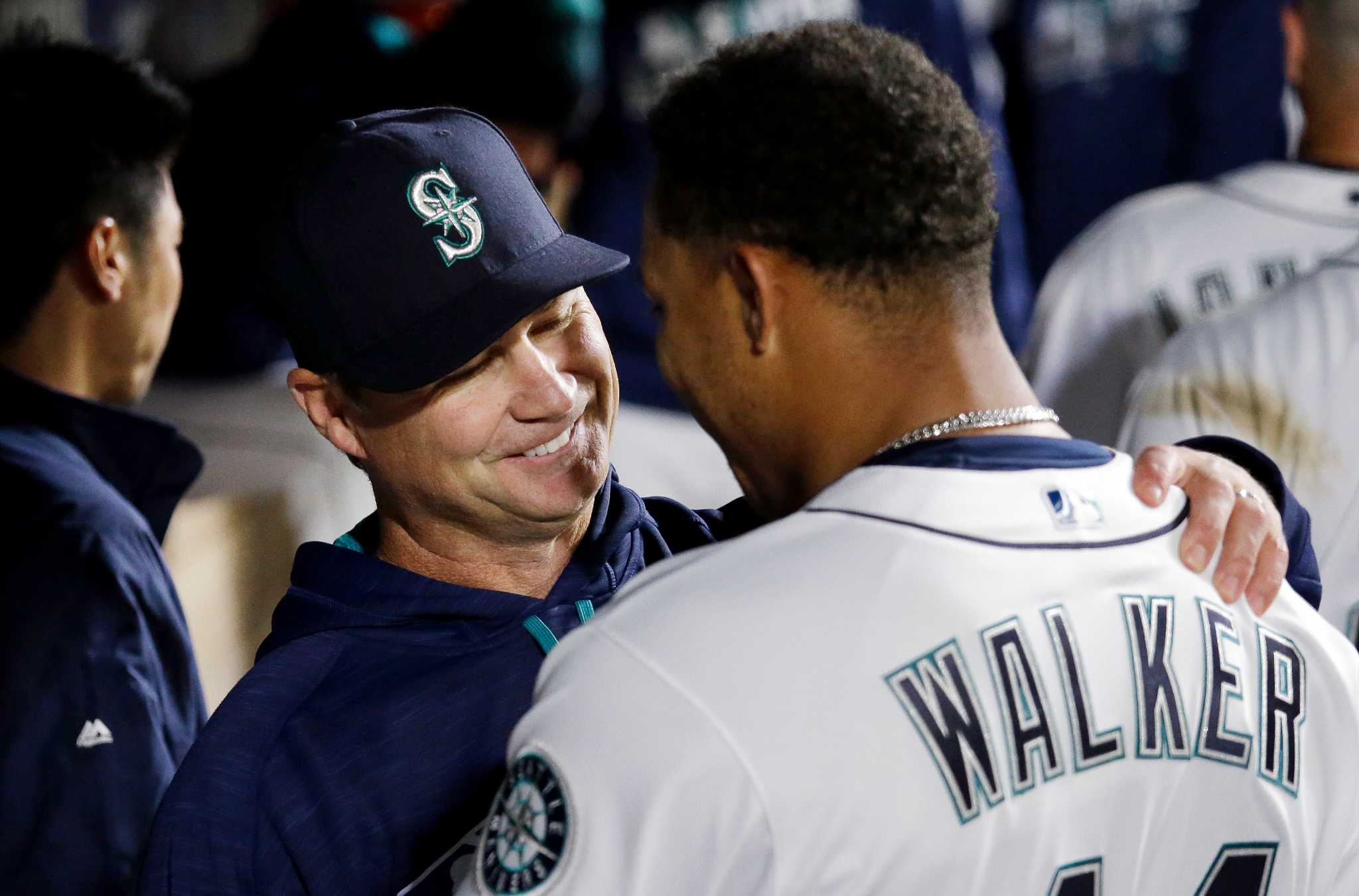 Ichiro Suzuki of the Seattle Mariners embraces manager Scott