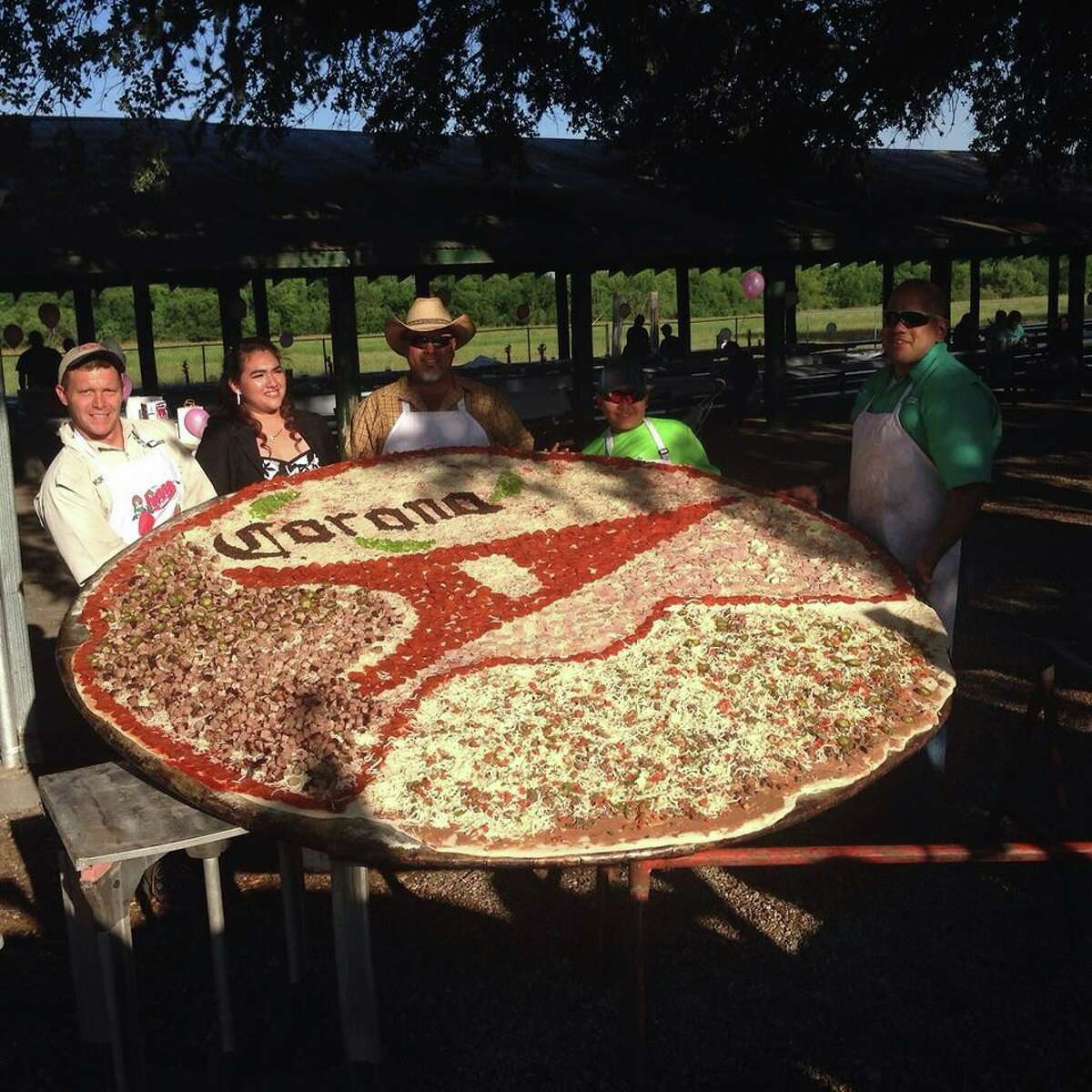 Kurt Oefinger, owner of Hondo-based Dirt Road Cookers, makes gigantic pizzas which measure 8 feet in diameter.