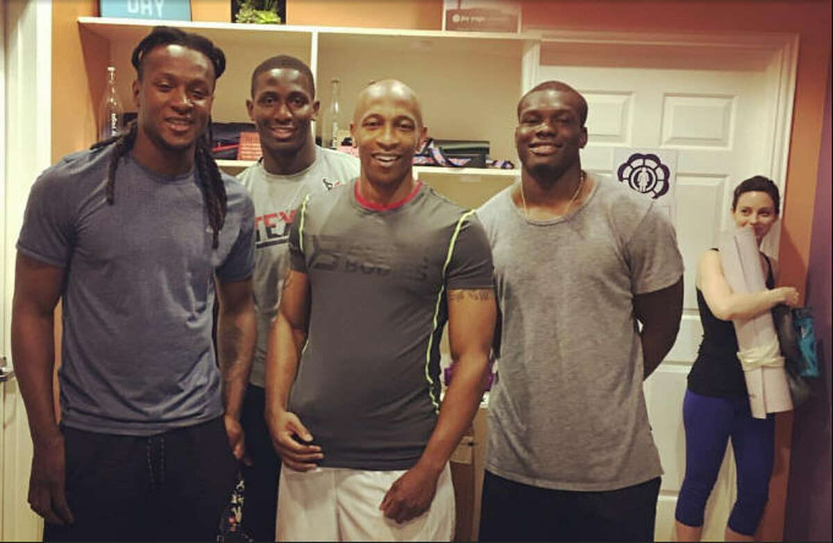 Texans players (from left) DeAndre Hopkins, Alfred Blue, Keith Mumphery and running backs coach Charles London (center) did some yoga at a Houston studio Thursday.