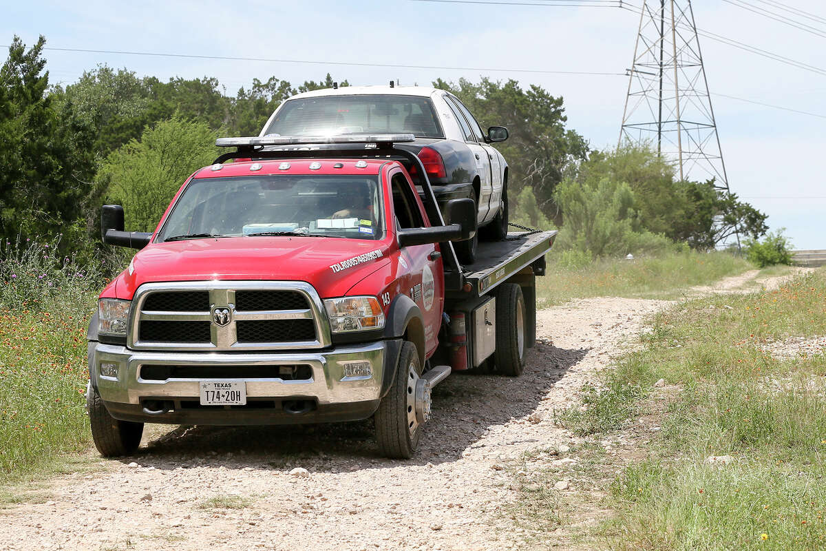 The first of two San Antonio Police crusiers is towded from inside the Martin Marietta Beckman Quarry on NW Military Hwy north of Loop 1604 W on Thursday, May 5, 2016 Highway, 2016. Officers apprehended Emanuel Gregory Martinez, 31, there after a carjacking attempt and a police chase that began on the South Side of San Antonio. MARVIN PFEIFFER/ mpfeiffer@express-news.net