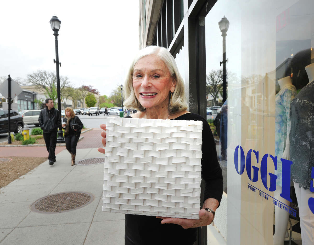 Artist Gail Resen who has a studio in Port Chester, N.Y., displays one of her canvass works during Art to the Avenue, the Greenwich Arts Council's spring celebration on Greenwich Avenue, Greenwich, Conn., Thursday, May 5, 2016. The festival opens each year on the first Thursday in May and runs to May 30. Over100 artists are featured in various Greenwich Avenue and central business district stores. "All art is for sale" reads the pamphlet for the show, contact the Greenwich Arts Council at 203-862-6750.