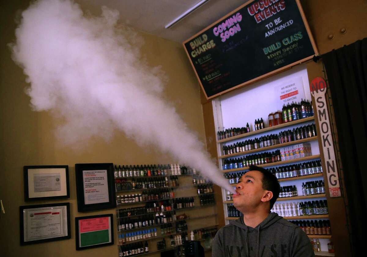 A user in San Francisco blows vapor from an e-cigarette.