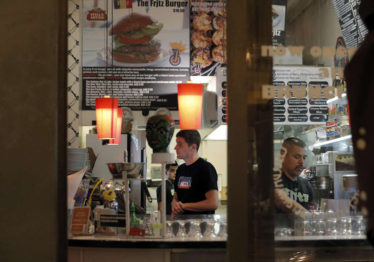 Employees are seen working through the front window during a night shift at Frjtz restaurant in San Francisco, Calif., on Wednesday, May 4, 2016.