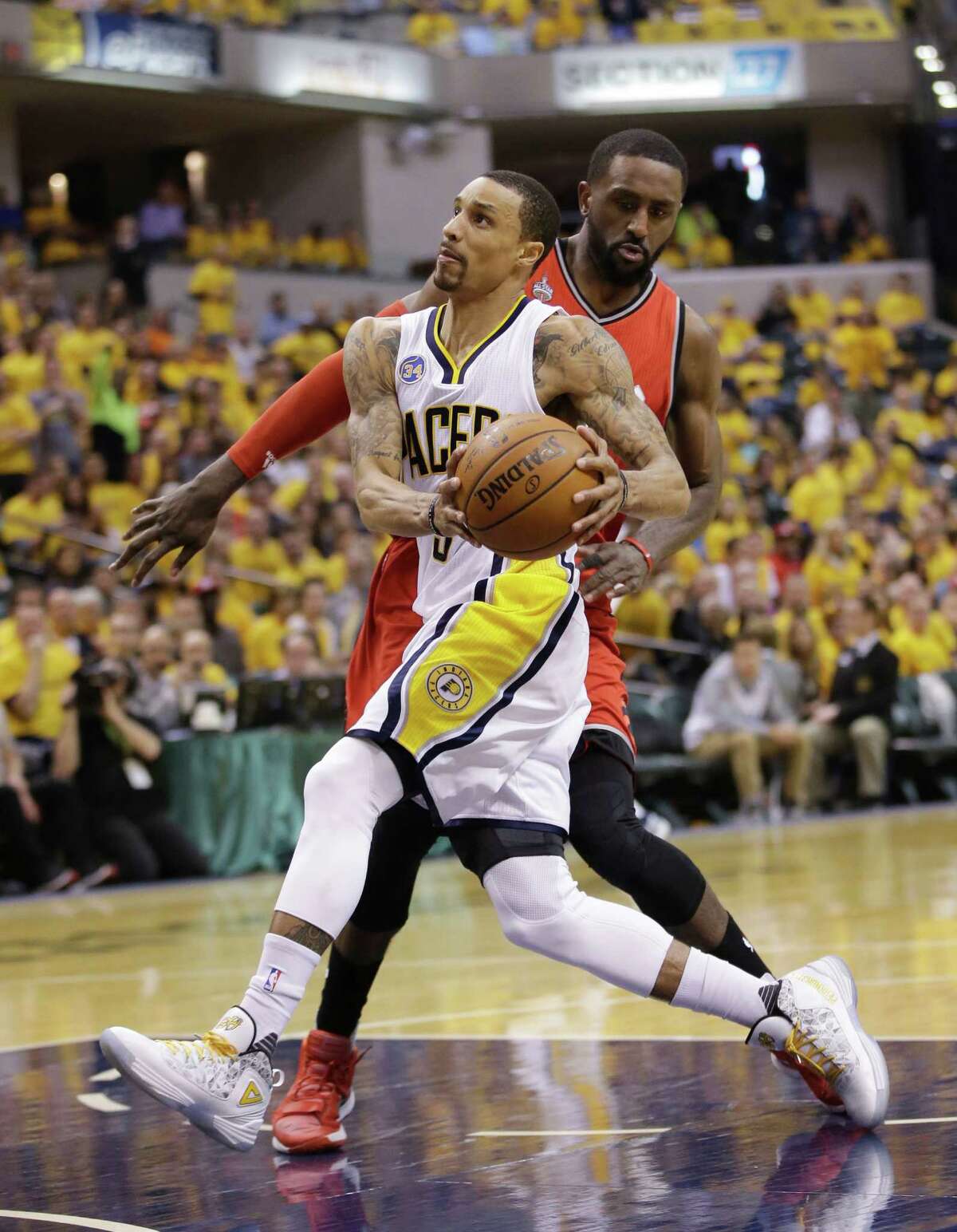 Indiana Pacers' George Hill (3) goes to the basket against Toronto Raptors' Patrick Patterson (54) during the second half of Game 6 of an NBA first-round playoff basketball series Friday, April 29, 2016, in Indianapolis. Indiana won 101-83. (AP Photo/Darron Cummings)