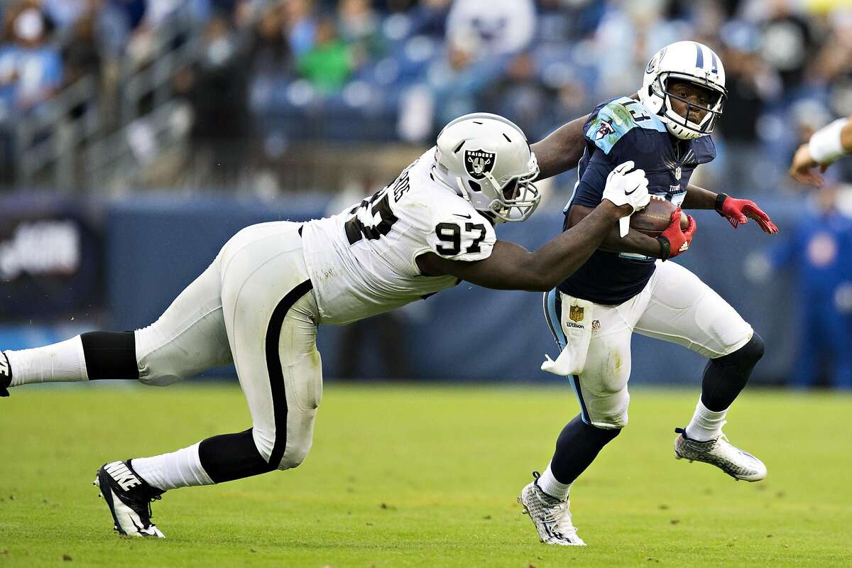 NASHVILLE, TN - NOVEMBER 29: Kendall Wright #13 of the Tennessee Titans is tackled from behind by Mario Edwards Jr. #97 of the Oakland Raiders at Nissan Stadium on November 29, 2015 in Nashville, Tennessee. (Photo by Wesley Hitt/Getty Images)