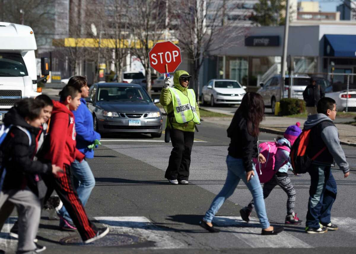 This year in Stamford, Conn., Mayor David Martin proposed raising wages earned by school crossing guards 26 percent over three years to $15 an hour. Betty Matthews is pictured on the job in March 2016 in Stamford.