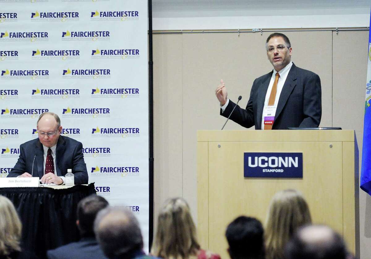 OperationsInc and AllCountyJobs.com CEO David Lewis, right, leads a panel discussion in April 2016 on corporate retention strategies, held at UConn Stamford in Stamford, Conn. as part of the Fairchester Recruiting Summit & Awards.