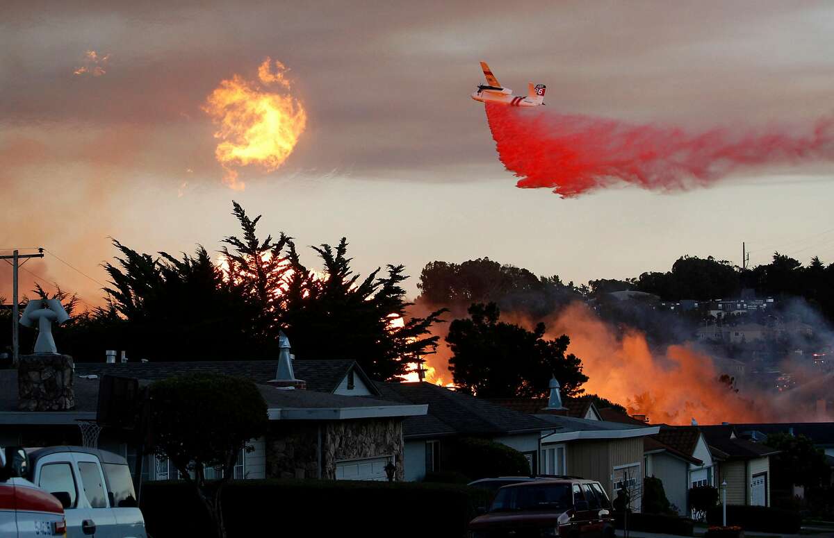 FILE - In this Sept. 9, 2010, file photo, a massive fire following a pipeline explosion roars through a mostly residential neighborhood in San Bruno, Calif. Repeated natural-gas accidents including a pipeline explosion that killed eight people suggest that Pacific Gas & Electric Co., California’s largest power utility, may be too big to operate safely, the state’s top utility regulator says. California Public Utilities Commission President Michael Picker said he would ask the commission’s staff to study “the culture of safety” and the structure of the utility, which he noted currently has its gas and electricity operations under a single board and CEO. PG&E is one of the country’s largest power utilities with 9.7 million gas and electric customers. The Associated Press obtained Picker’s prepared statement ahead of a commission meeting Thursday, April 9, 2015, where the panel is expected to vote on a record $1.6 billion penalty for the 2010 PG&E gas pipeline explosion in a San Francisco suburb. (AP Photo/Jeff Chiu, File)