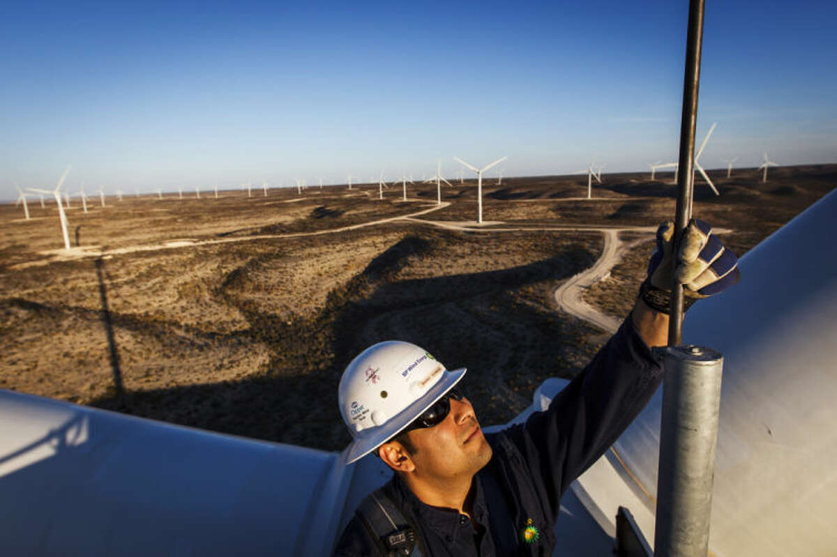 Manny Dominguez, Deputy Facility Manager of the BP Sherbino Mesa II Wind Farm, checks a lighting rod for damage from 285ft atop turbine 53, BP's 1000th wind turbine, Monday, Feb. 20, 2012, in Fort Stockton. After cutting its solar program last year, BP is beefing up its investments into wind energy and recently launched its fourth Texas wind farm, in Fort Stockton. On 20,000 acres in Pecos County, the Sherbino II farm has 60 wind turbines to generate enough electricity to power more than 175,000 homes. ( Michael Paulsen / Houston Chronicle )