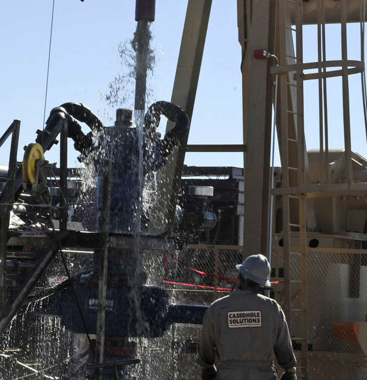 Water gushes out of a drilling pipe as it is pulled up to be replaced with a fresh pipe at a hydraulic fracturing site in Midland, Texas, Sept. 24, 2013. The drilling method known as fracturing uses huge amounts of high-pressure, chemical-laced water to free oil and natural gas trapped deep in underground rocks. With fresh water not as plentiful companies have been looking for ways to recycle their waste. (AP Photo/Pat Sullivan)  