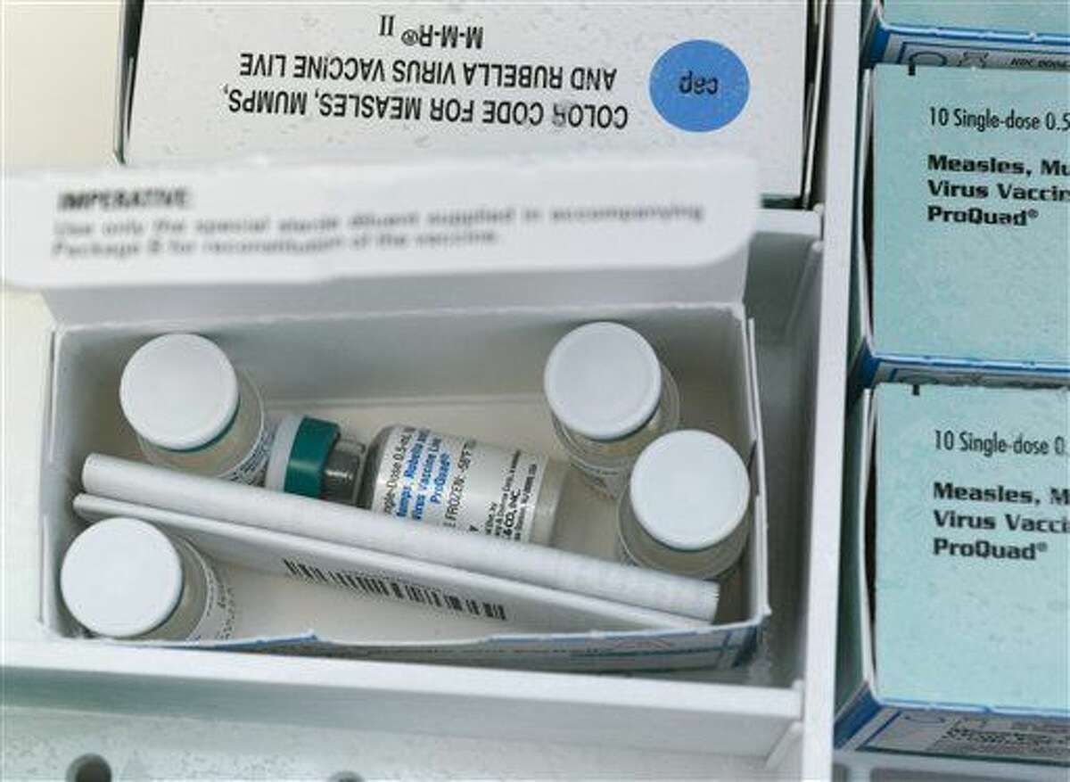 In this Thursday, Jan. 29, 2015, photo, boxes of single-doses vials of the measles-mumps-rubella virus vaccine live, or MMR vaccine and ProQuad vaccine are keep frozen inside a freezer at the practice of Dr. Charles Goodman in Northridge, Calif. 