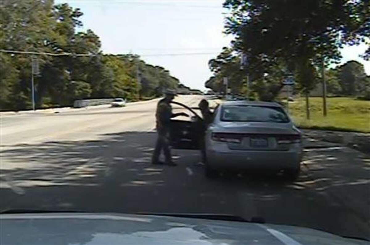 FILE - In this July 10, 2015, file frame from dashcam video provided by the Texas Department of Public Safety, Texas State Trooper Brian Encinia confronts Sandra Bland after a minor traffic infraction in Waller County,Texas. A grand jury decided that neither sheriff's officials nor jailers committed a crime in the treatment of Bland, a black woman who died in a Texas county jail last summer. But it has not yet determined whether Encinia, who arrested her, should face charges, a prosecutor said on Tuesday, Dec. 22, 2015. (Texas Department of Public Safety via AP, file)