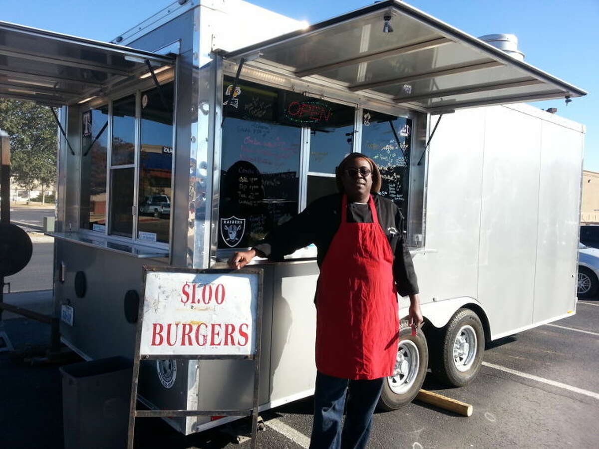 (File Photo) Todd Brown, owner of the Brown's BBQ food trailer, stands in front of his mobile kitchen in the Best Buy parking lot on Dec. 26, 2013. Brown is the head of a mobile food vendor association in Midland and hopes to start a food truck park in downtown Midland.
