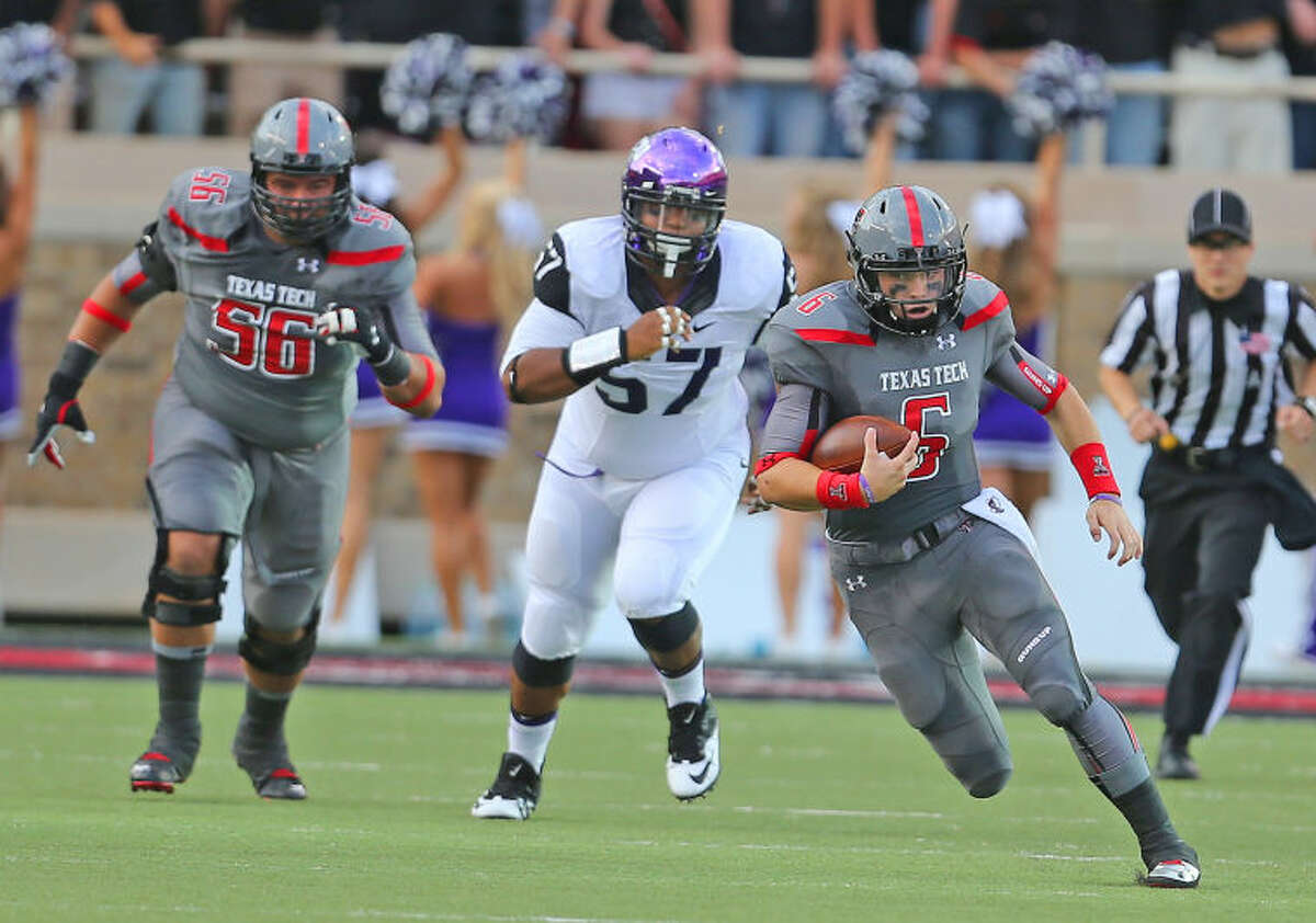 Texas Tech quarterback Baker Mayfield (6) goes for a big gain against the TCU defense in Thursday nights Big XII matchup at Jones AT & T stadium.