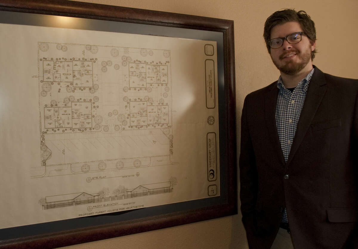 Jordan Parnell stands next to the original blue prints of Buckner homes Tuesday, 1-20-15, in his new office as executive director for Buckner Children and Family Services. Tim Fischer\Reporter-Telegram