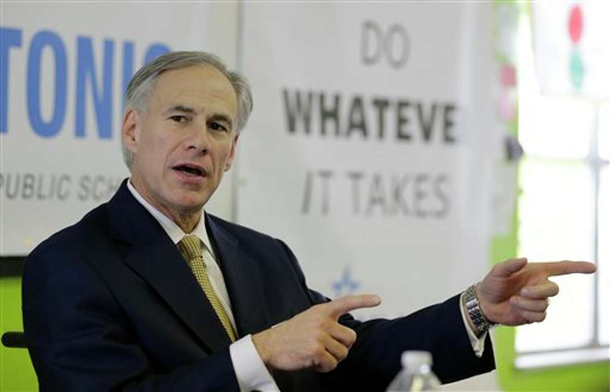 FILE - In this Dec. 11, 2013 file photo, Republican Attorney General Greg Abbott talks with educators at KIPP: San Antonio, in San Antonio, Texas. Abbott raised $11.5 million over three months, and Fort Worth Democrat Wendy Davis raised more than $12 million over the past six months, the campaigns reported Tuesday, Jan. 14, 2014. (AP Photo/Eric Gay, File)