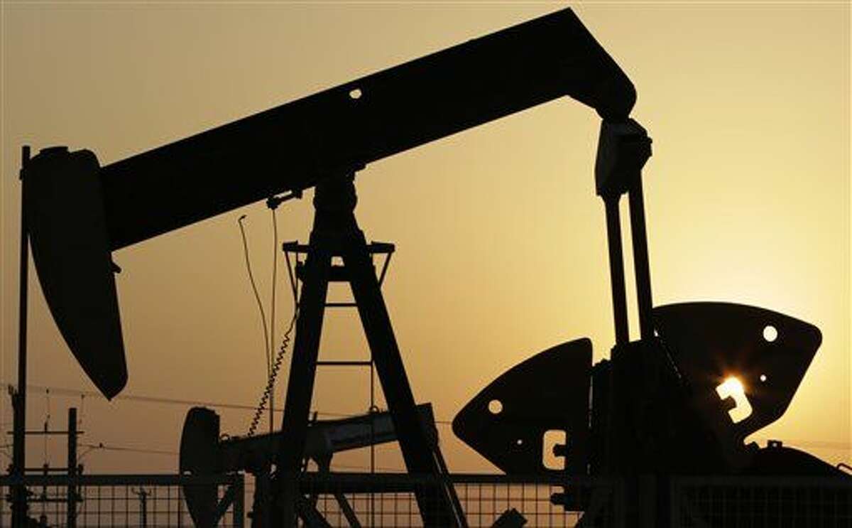 FILE -- In this Sept. 30, 2015, file photo, oil pumps work in the desert oil fields of Sakhir, Bahrain. (AP Photo/Hasan Jamali, File)
